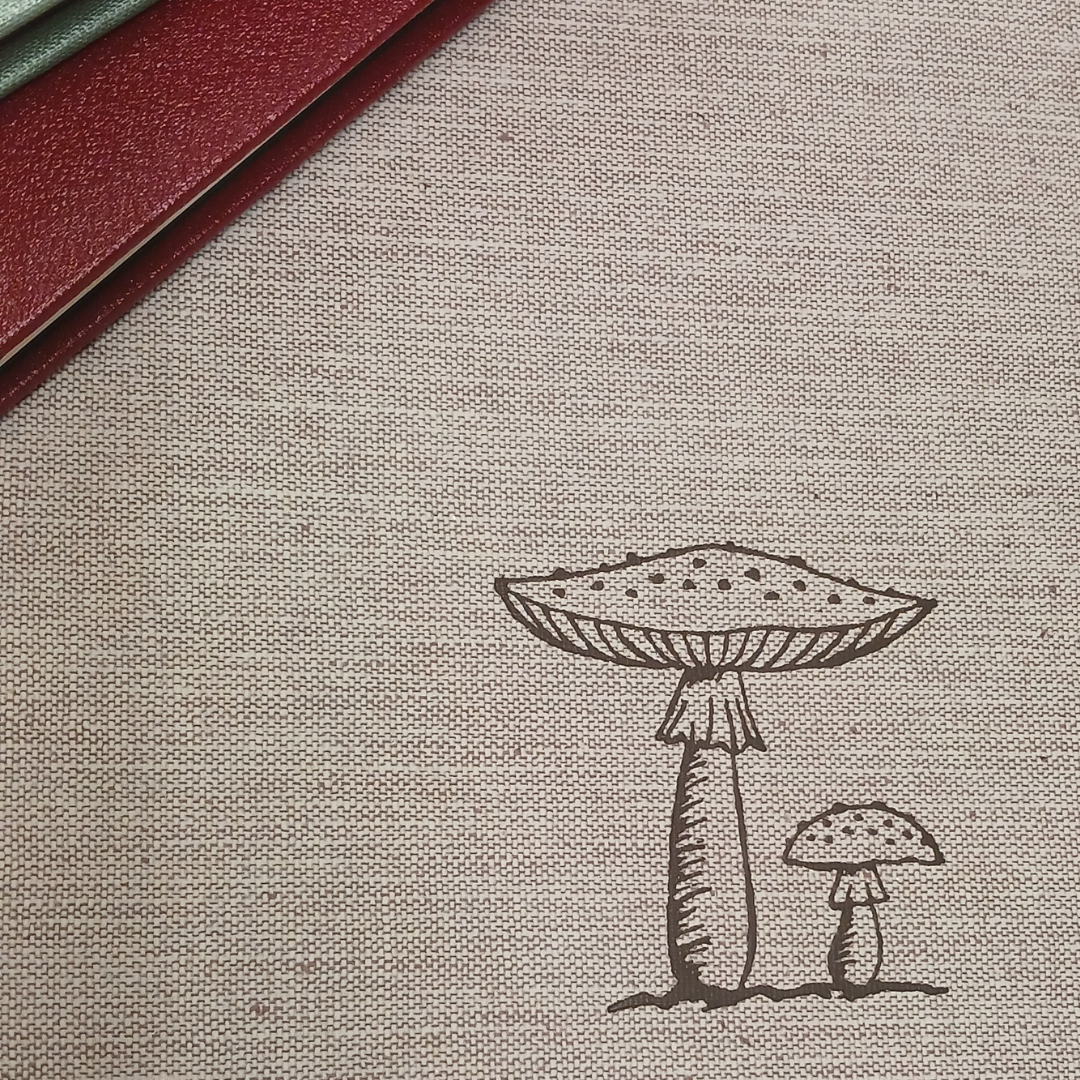 Embossed design of two mushrooms on natural beige linen fabric